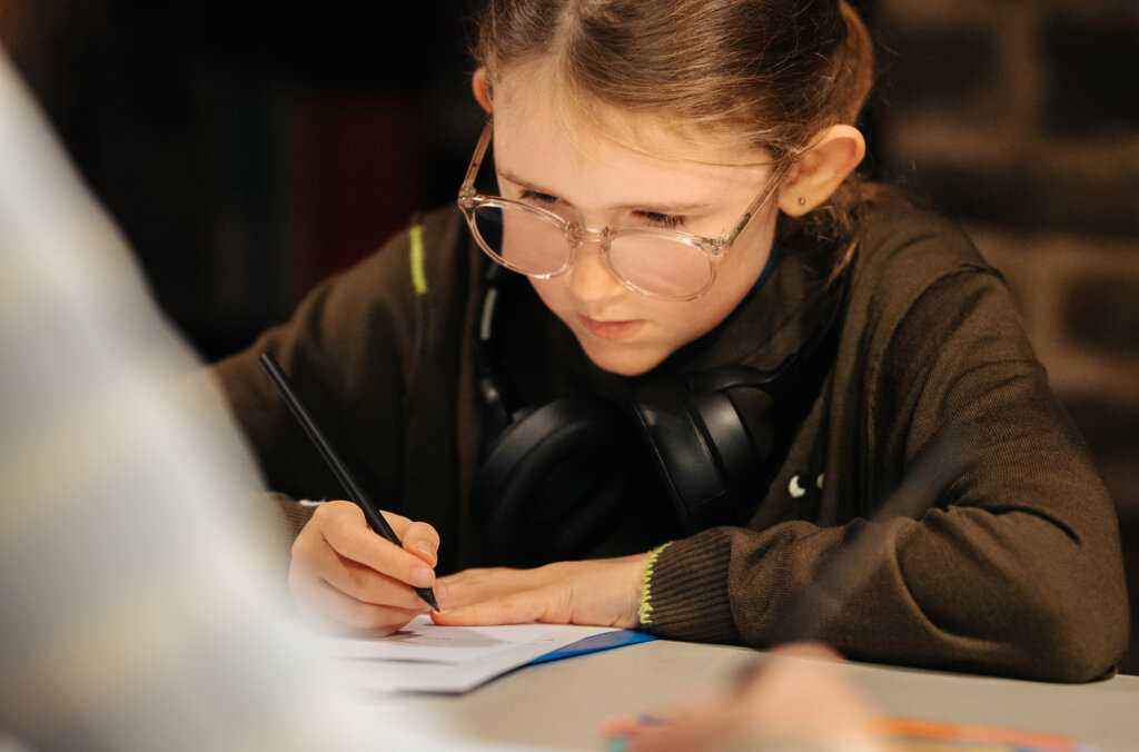 Child writing at the museum