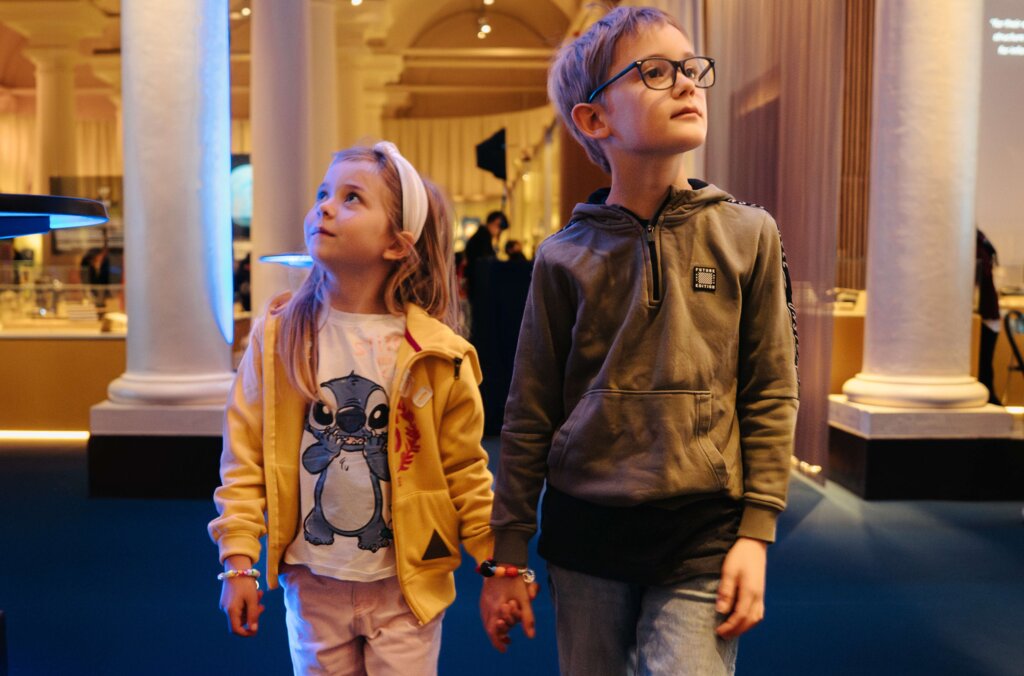 Two children walking through the Nobel Prize Museum.