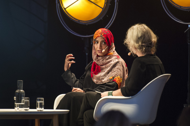 Two women talking on a stage