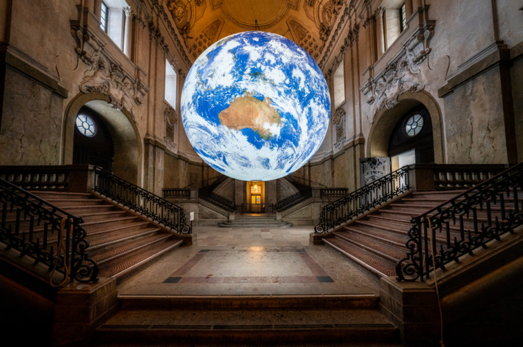 A big, glowing sphere, depicting the earth, hanging inside the Royal castle in Stockholm