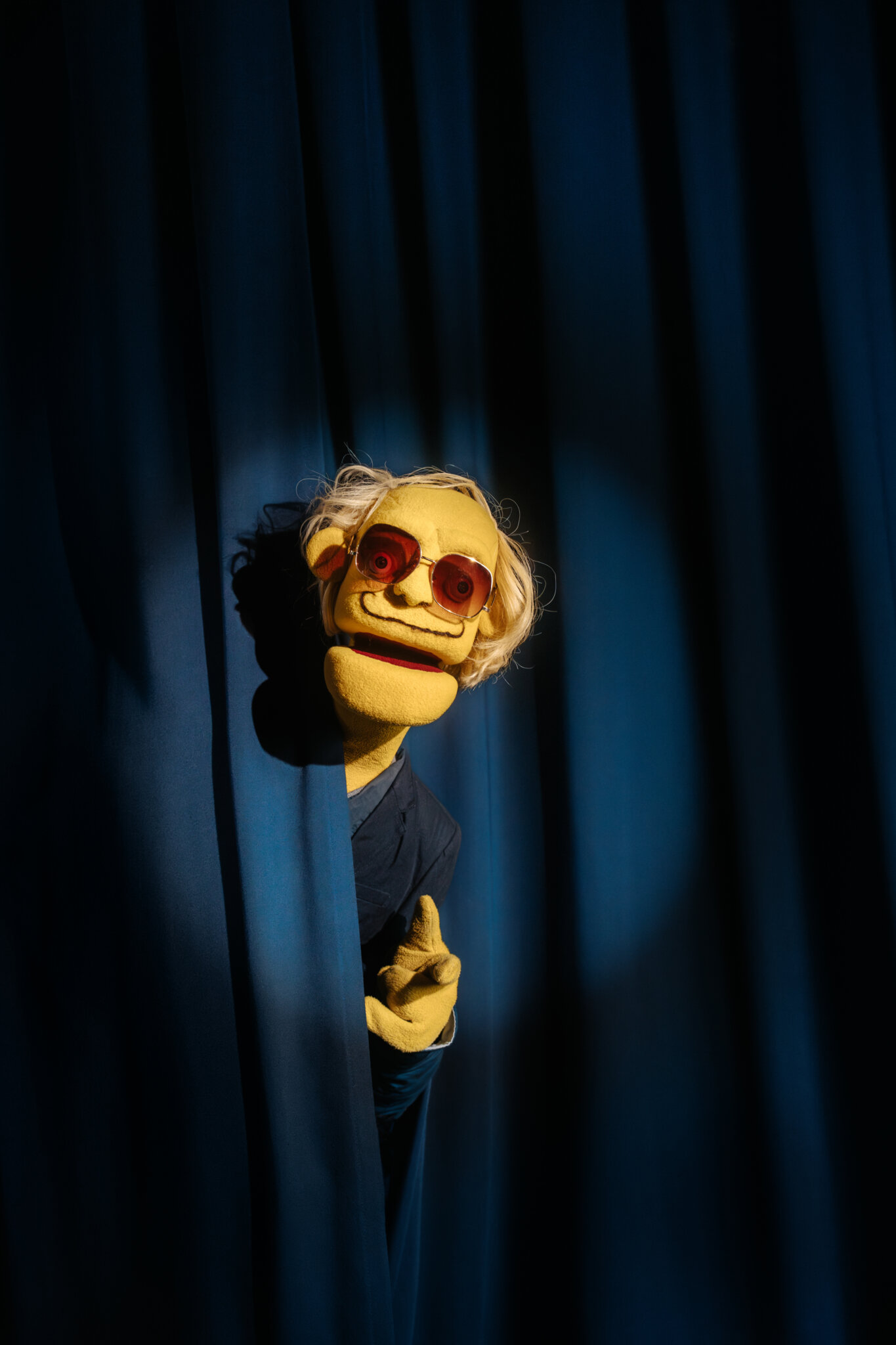 A photo of the character Tord, looking out of a curtain